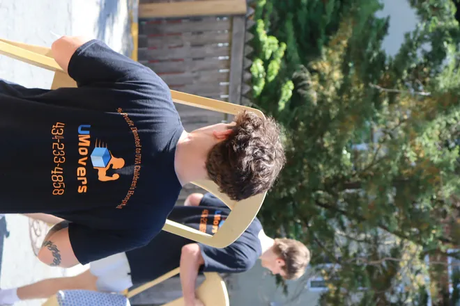 UMovers team moving furniture together